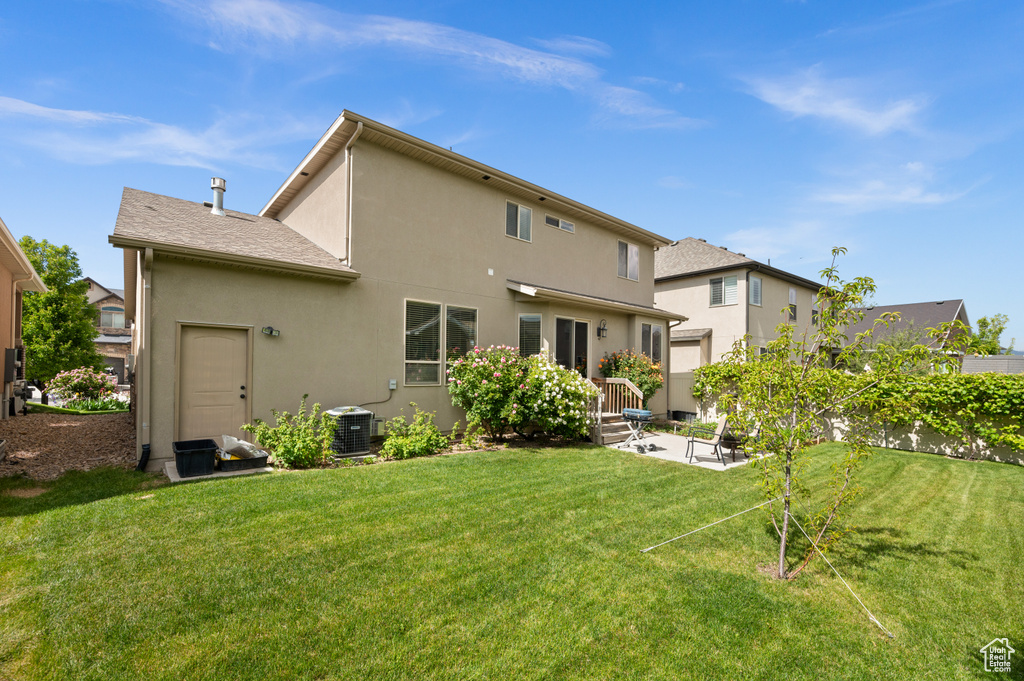 Rear view of house featuring stucco siding and a patio area