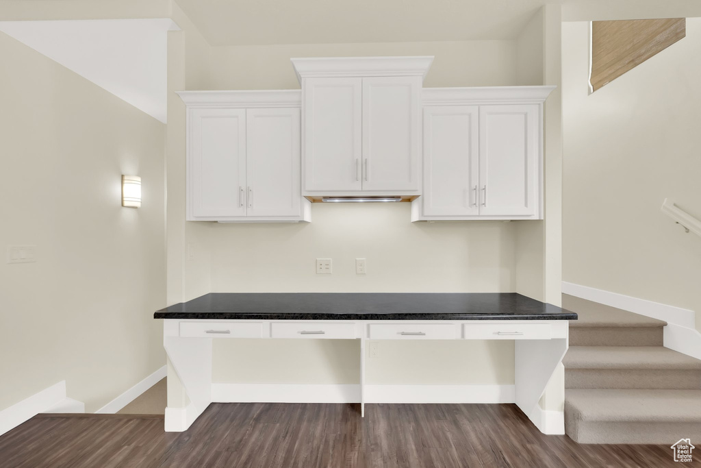 Unfurnished office featuring dark wood finished floors and baseboards