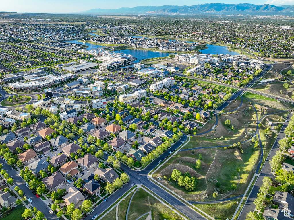 Aerial view of property and surrounding area featuring a water and mountain view