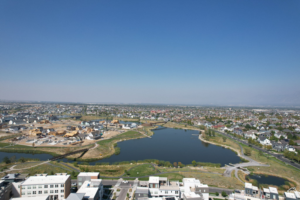 Aerial overview of property\'s location with a large body of water and nearby suburban area