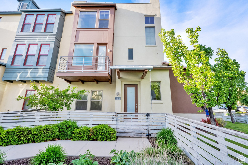 View of property featuring stucco siding and a balcony
