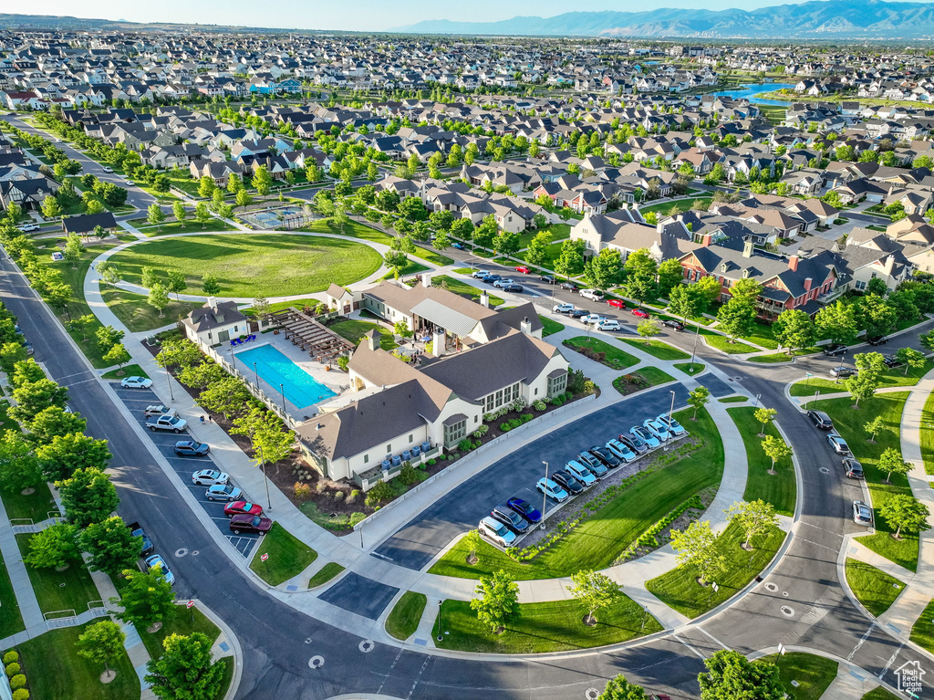 Aerial view of residential area featuring mountains and a pool area