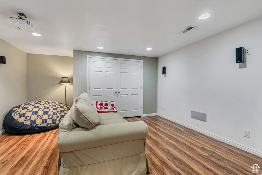Living area featuring baseboards, wood finished floors, and recessed lighting