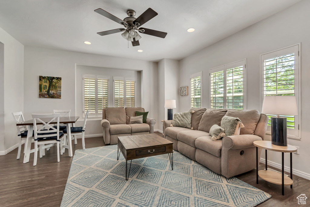 Living room with baseboards, wood finished floors, a ceiling fan, and recessed lighting