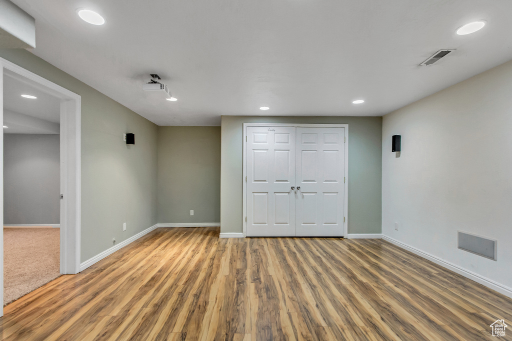 Unfurnished bedroom with baseboards, wood finished floors, a closet, and recessed lighting