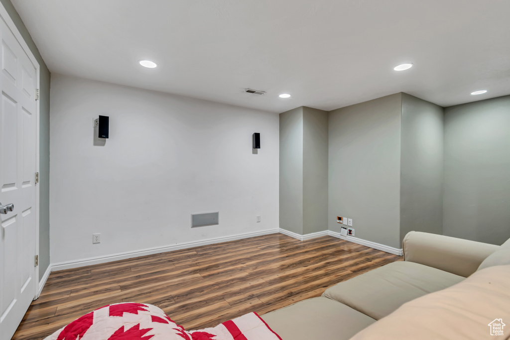 Living area featuring wood finished floors, baseboards, and recessed lighting