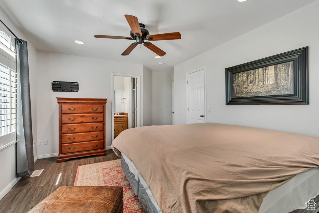 Bedroom featuring dark wood-style flooring, recessed lighting, baseboards, ensuite bath, and ceiling fan