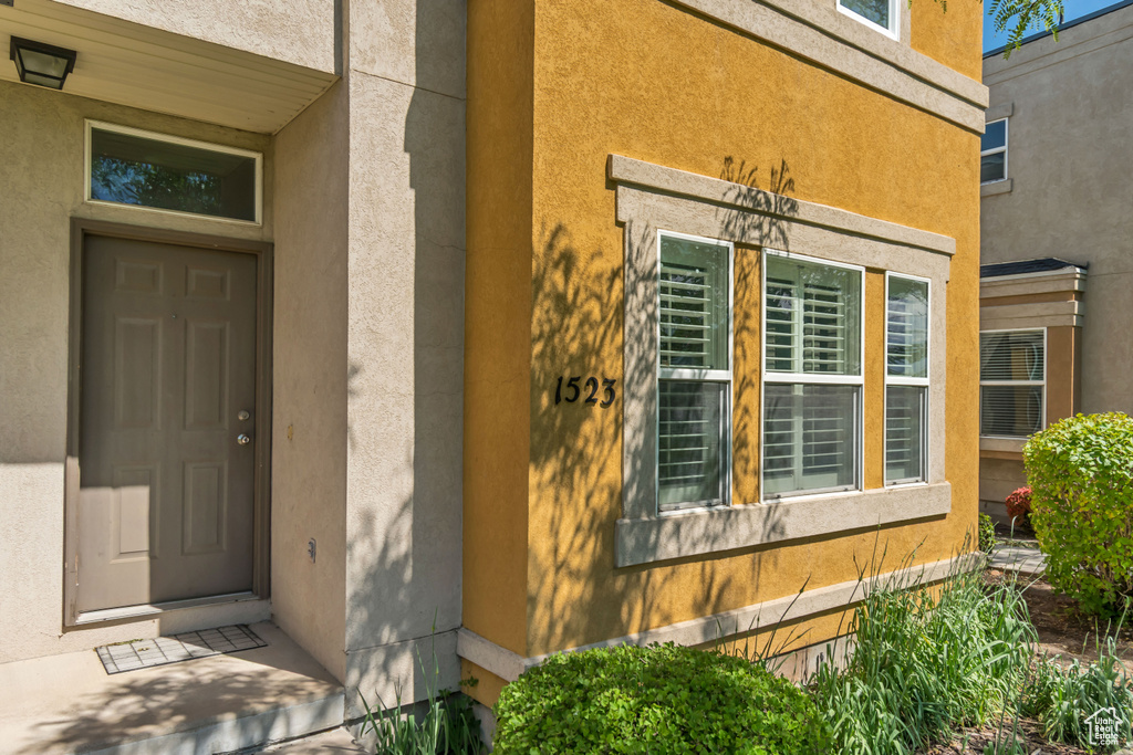 Entrance to property with stucco siding