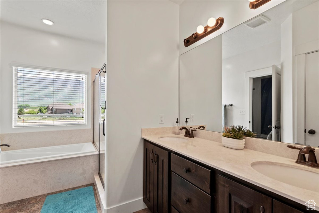 Bathroom with double vanity, a bath, an enclosed shower, and tile patterned floors
