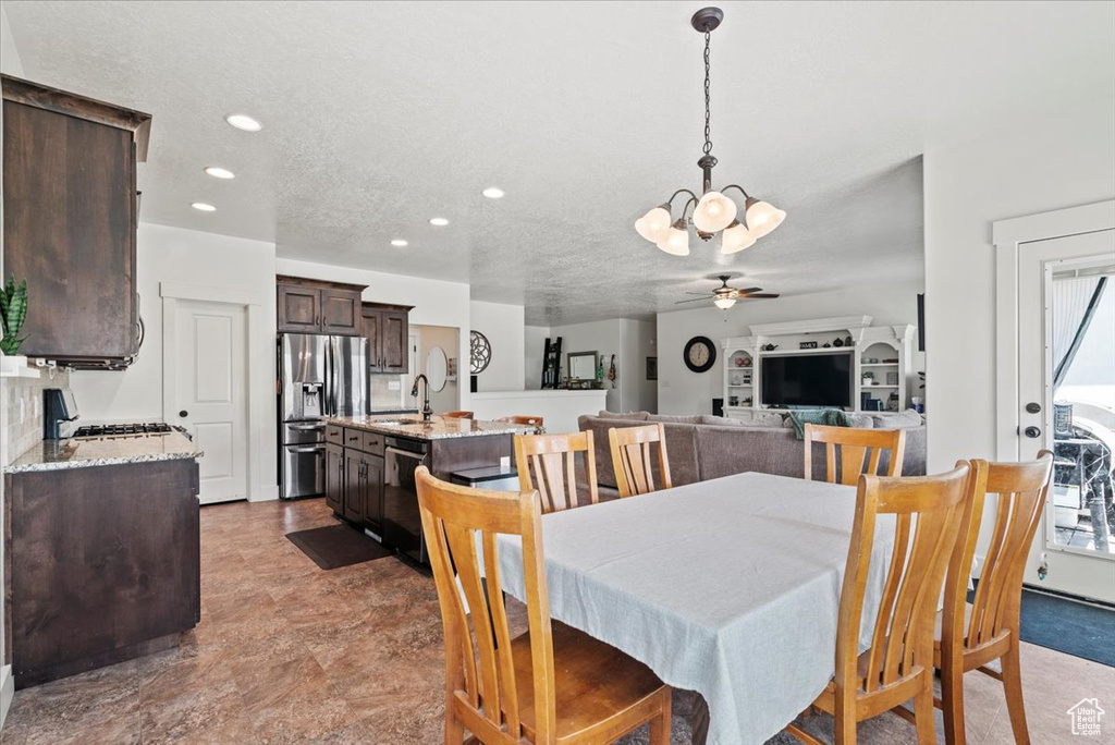 Dining room featuring a chandelier, recessed lighting, and ceiling fan