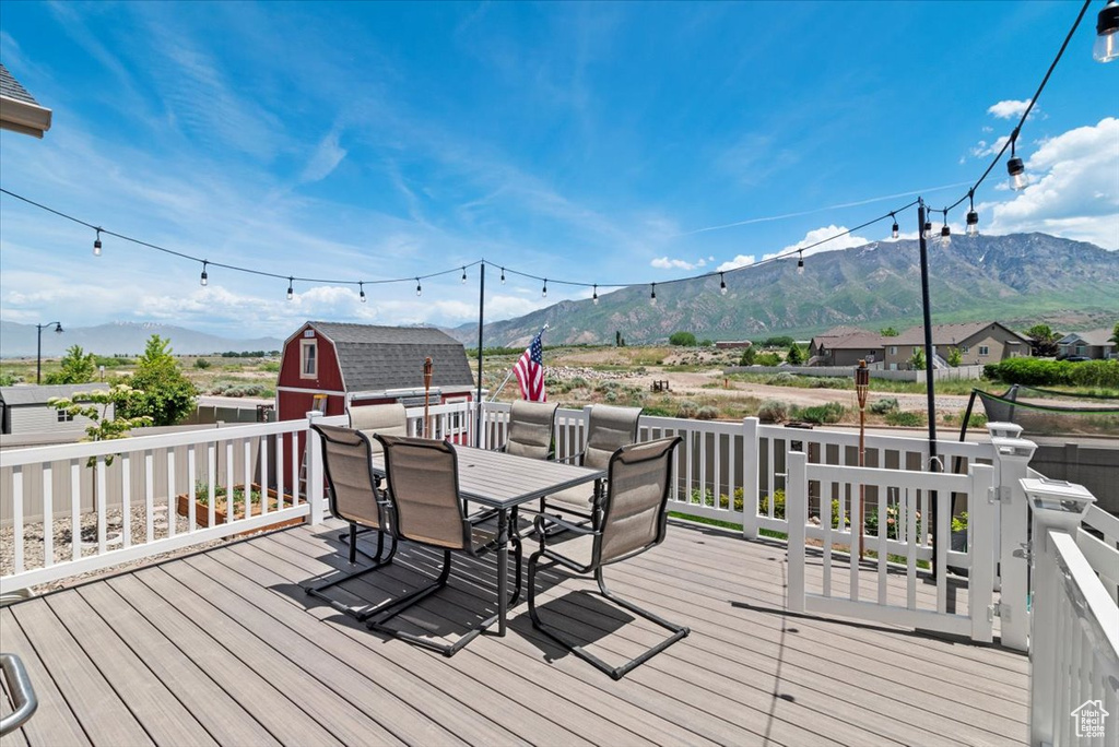 Deck with a mountain view and outdoor dining space