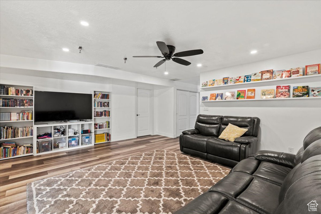 Living room featuring wood finished floors, recessed lighting, and a ceiling fan