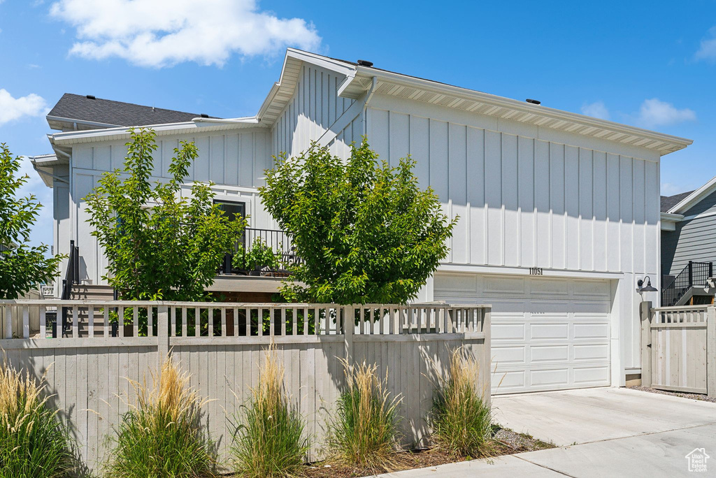 View of front of property featuring driveway and board and batten siding