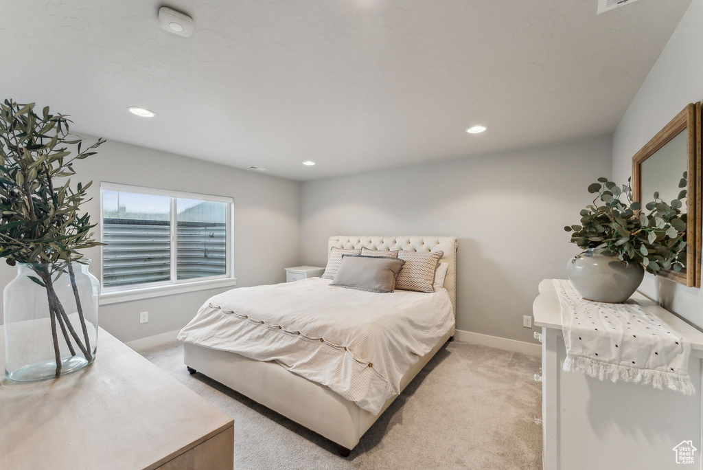 Bedroom featuring light carpet, baseboards, and recessed lighting