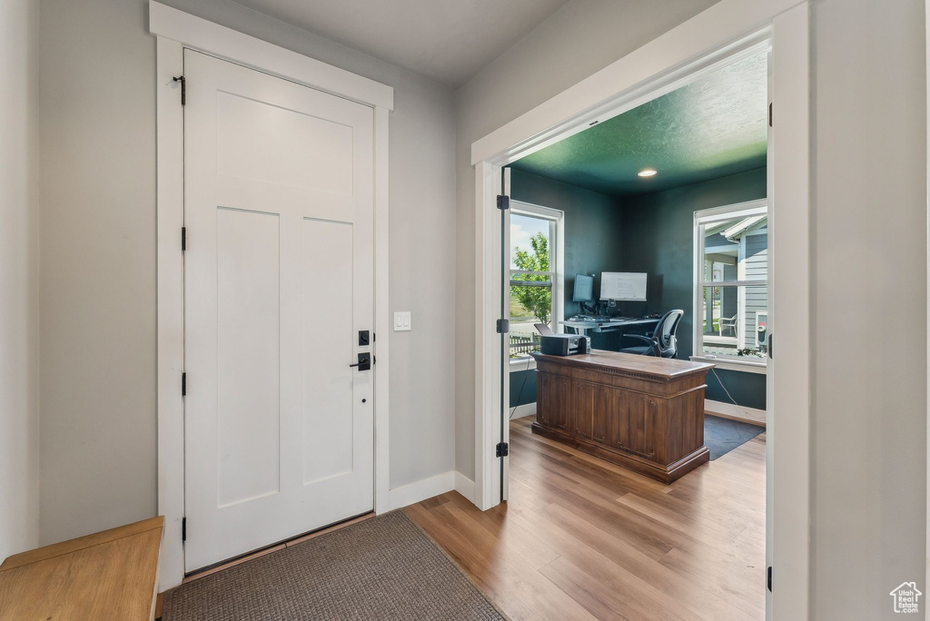 Entryway with wood finished floors and baseboards