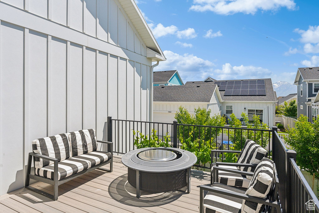 Deck featuring an outdoor living space with a fire pit and a residential view