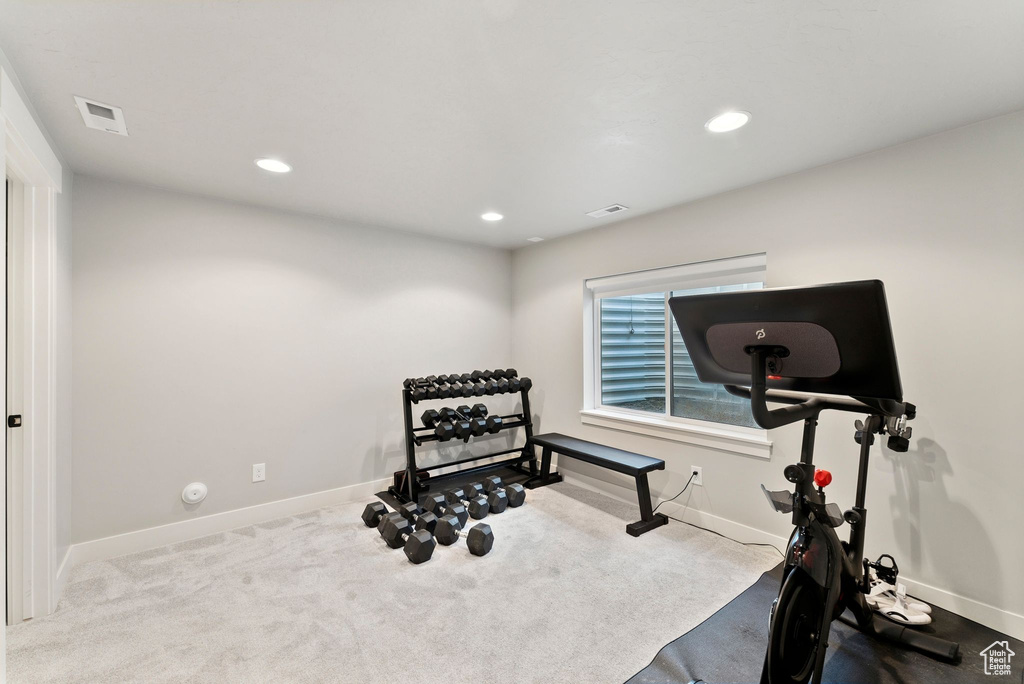 Exercise area with carpet, baseboards, and recessed lighting