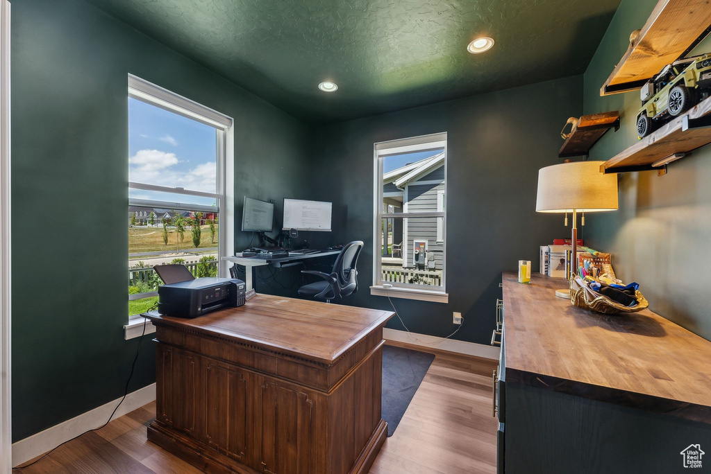 Office featuring wood finished floors, recessed lighting, baseboards, and a textured ceiling