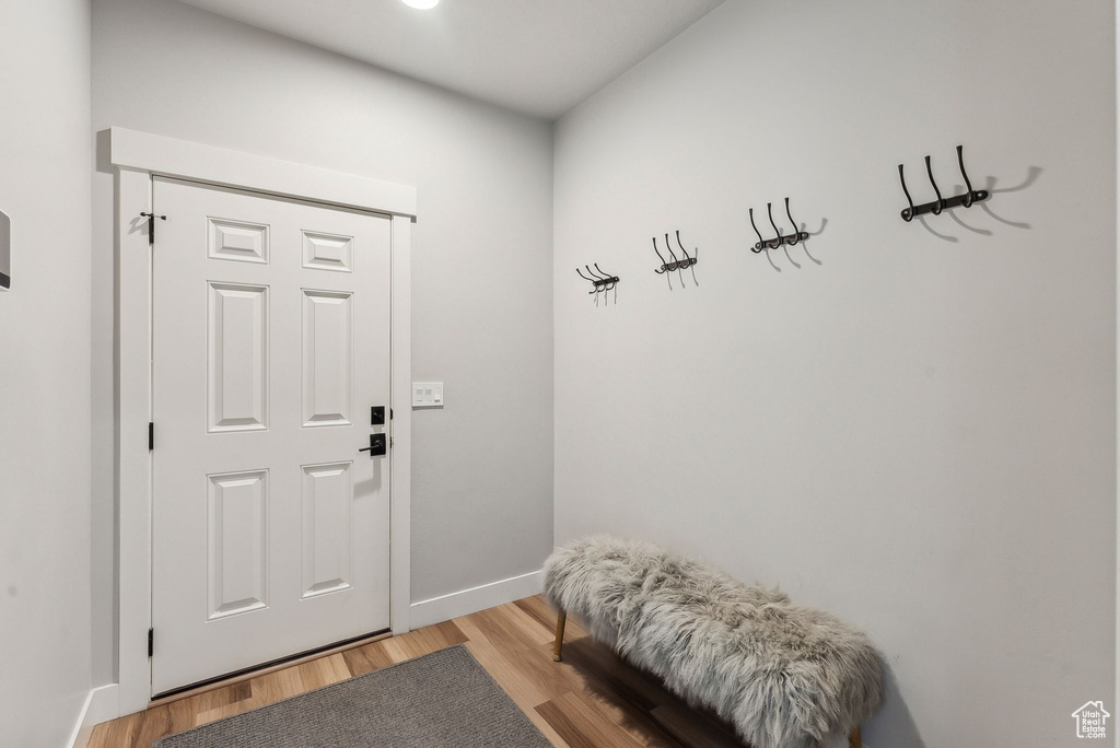 Mudroom with light wood-style floors and baseboards
