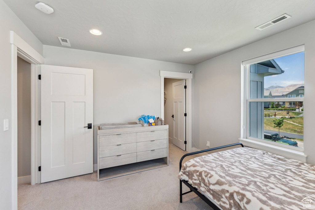 Bedroom featuring light carpet, recessed lighting, and baseboards