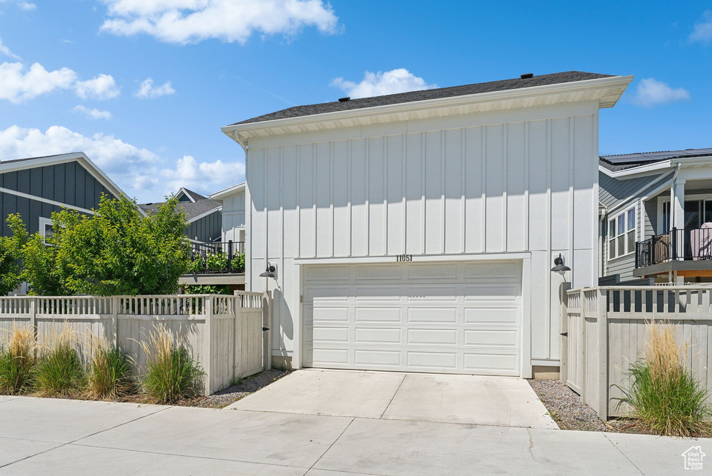 View of front of home featuring board and batten siding, a garage, and driveway