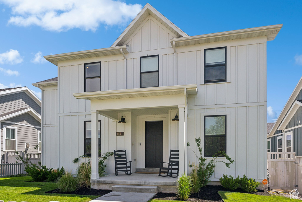 View of front of property featuring board and batten siding and covered porch