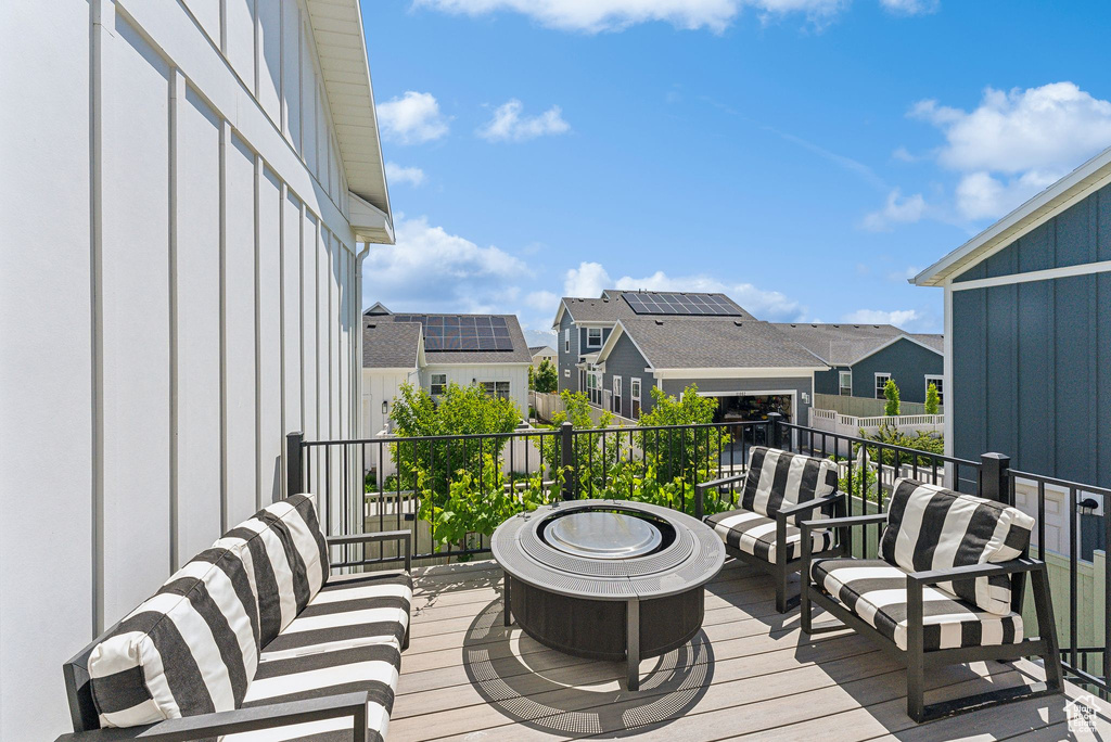 Wooden terrace with a residential view and an outdoor fire pit