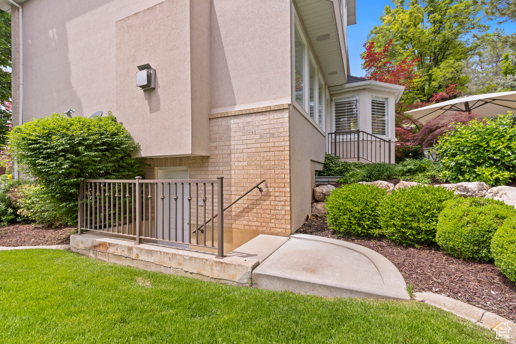 Entrance to property featuring stucco siding and stone siding