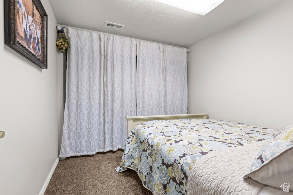 Carpeted bedroom featuring baseboards
