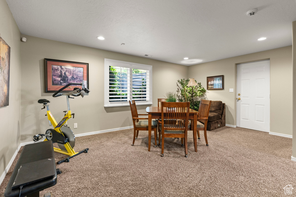 Carpeted dining area with baseboards and recessed lighting
