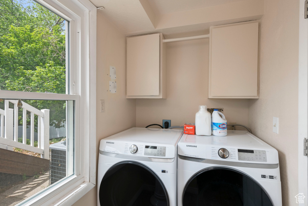 Laundry area with washing machine and clothes dryer and cabinet space