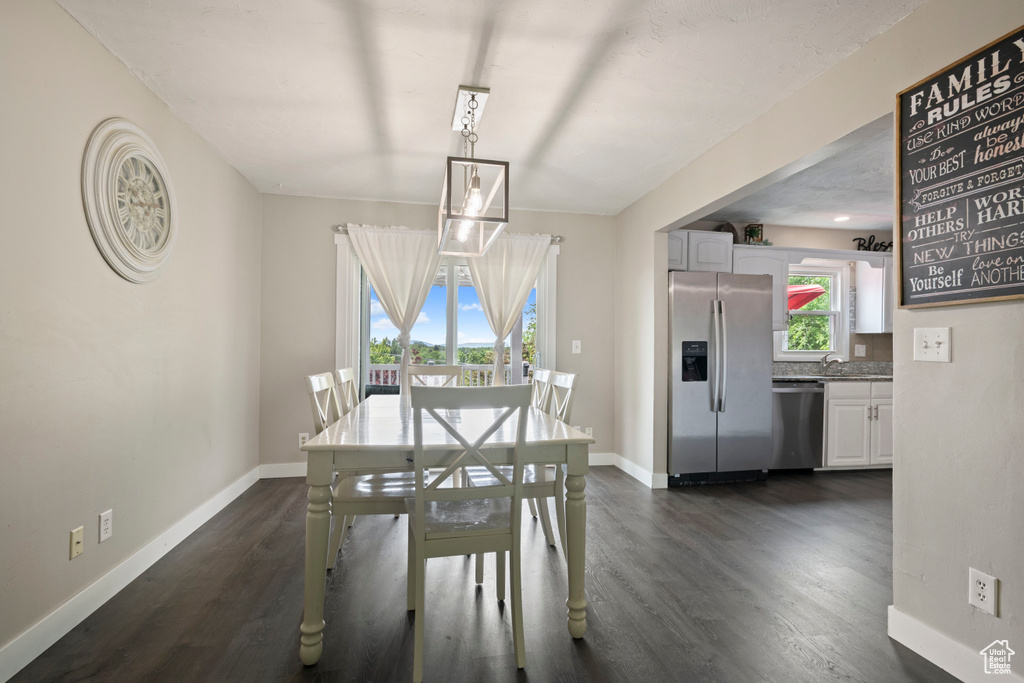 Dining room featuring baseboards and dark wood finished floors