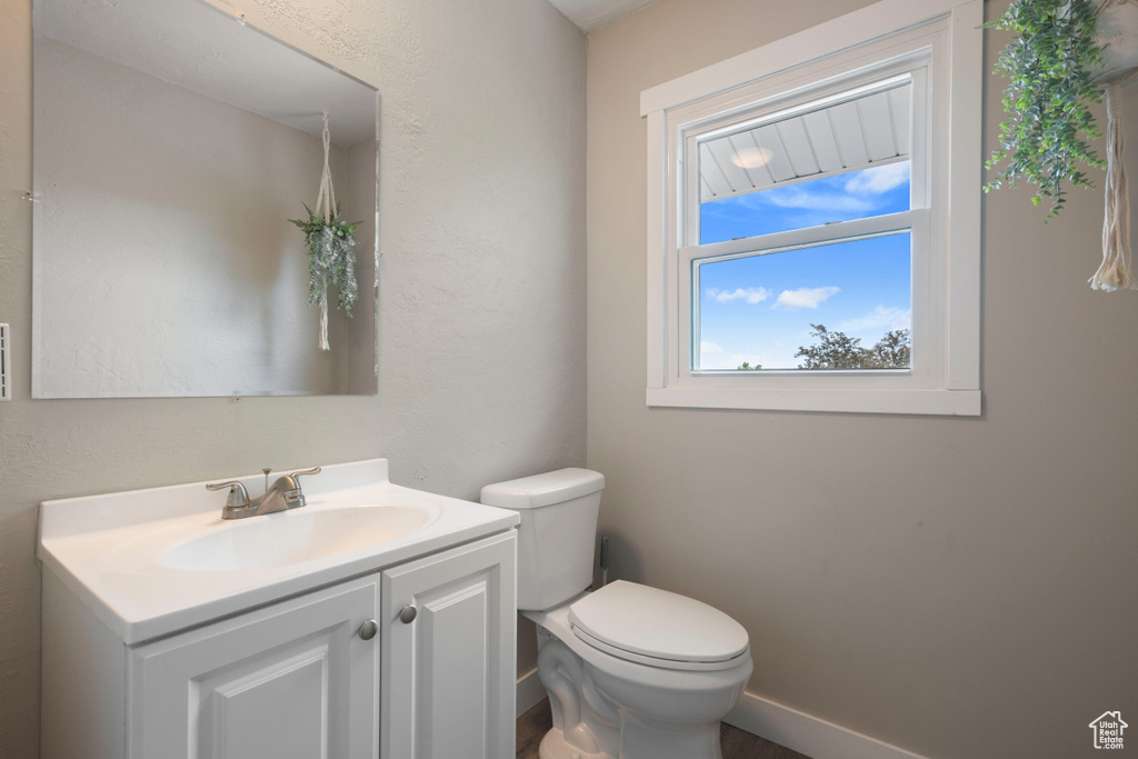 Half bathroom with vanity and toilet
