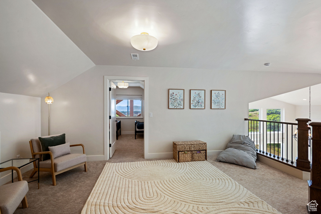 Bedroom with carpet floors, lofted ceiling, and baseboards