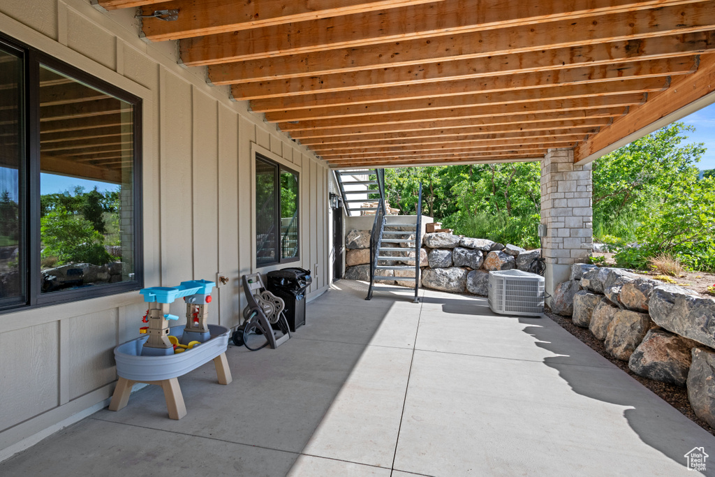 View of patio / terrace featuring stairway and cooling unit
