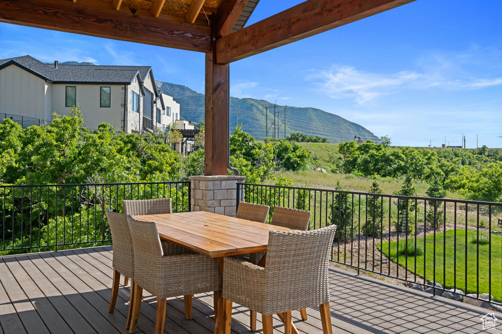 Deck featuring a mountain view and outdoor dining space