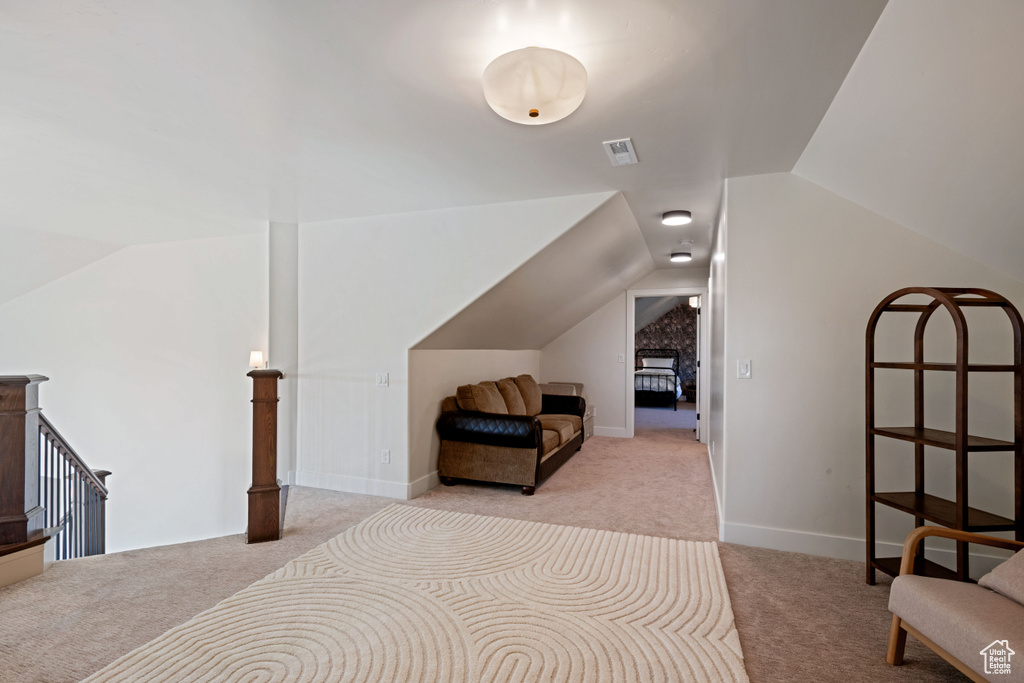 Bedroom with carpet flooring and lofted ceiling