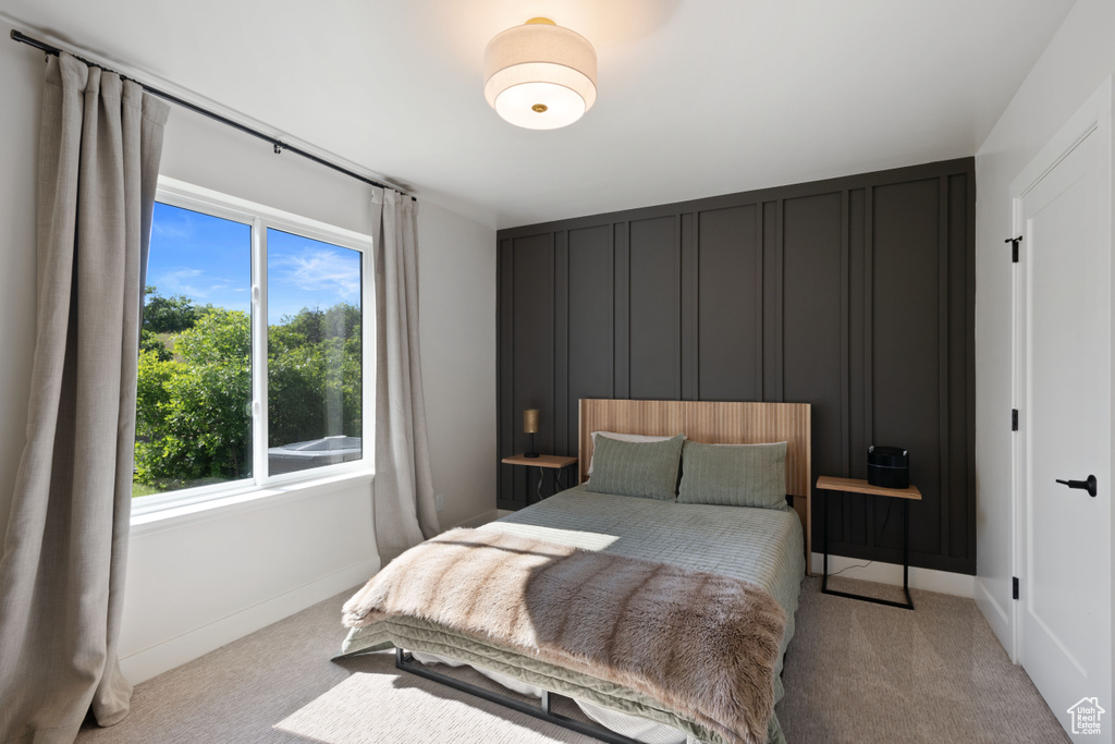 Bedroom featuring multiple windows, carpet floors, and baseboards