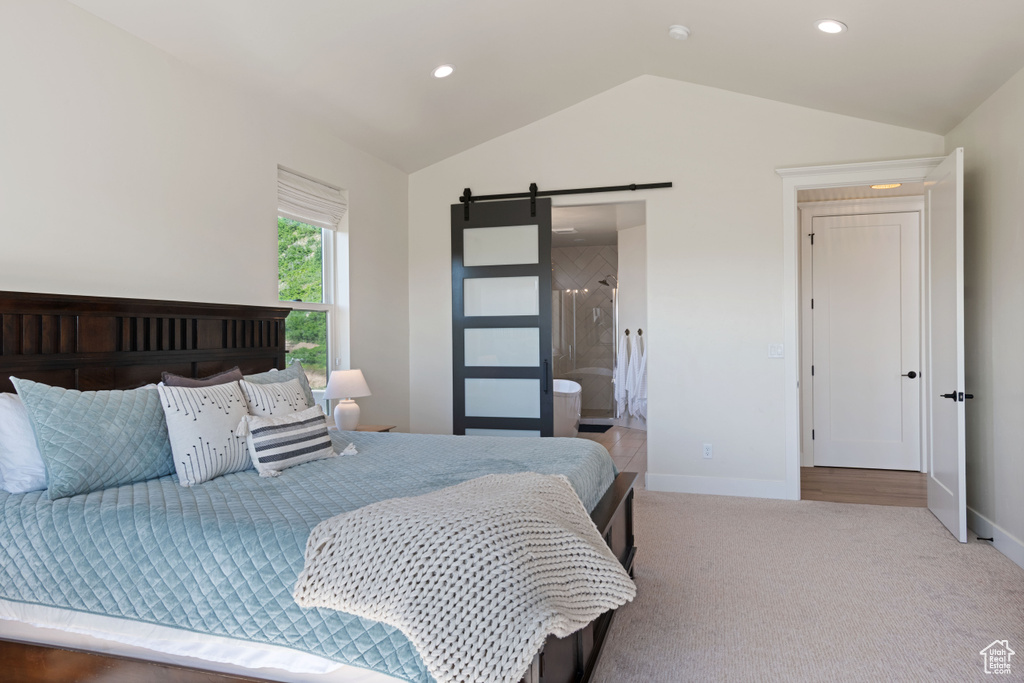 Bedroom with vaulted ceiling, a barn door, baseboards, carpet flooring, and recessed lighting