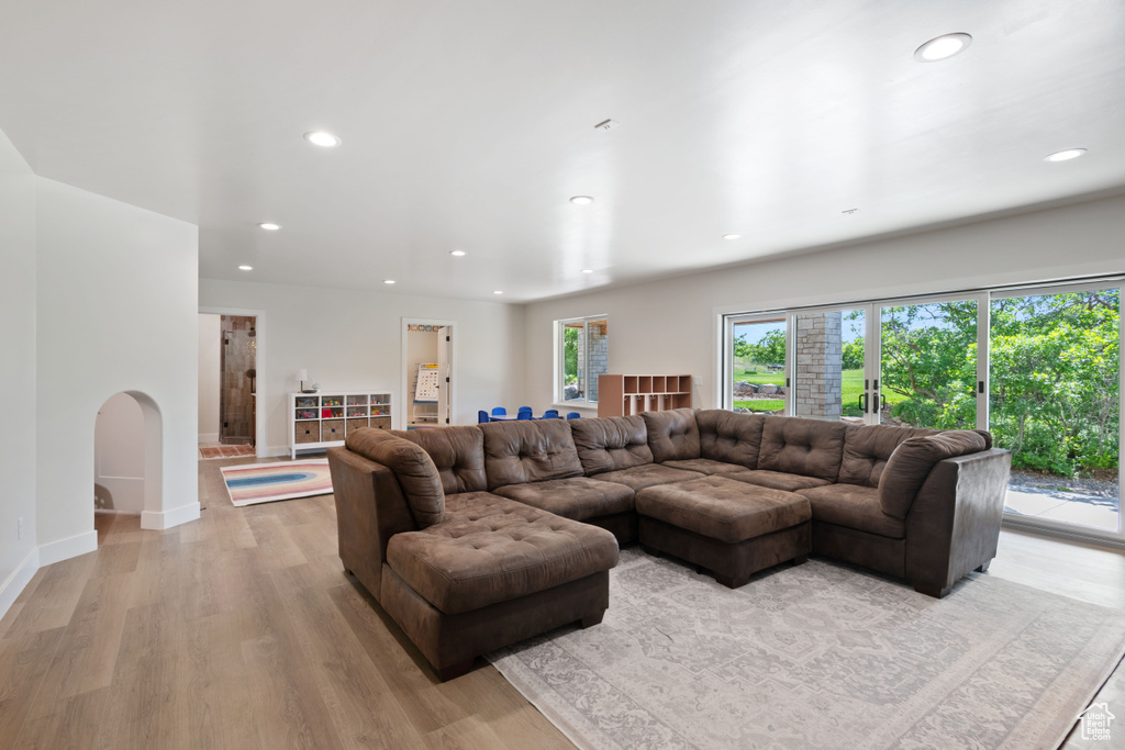 Living area with recessed lighting, light wood-style floors, and baseboards
