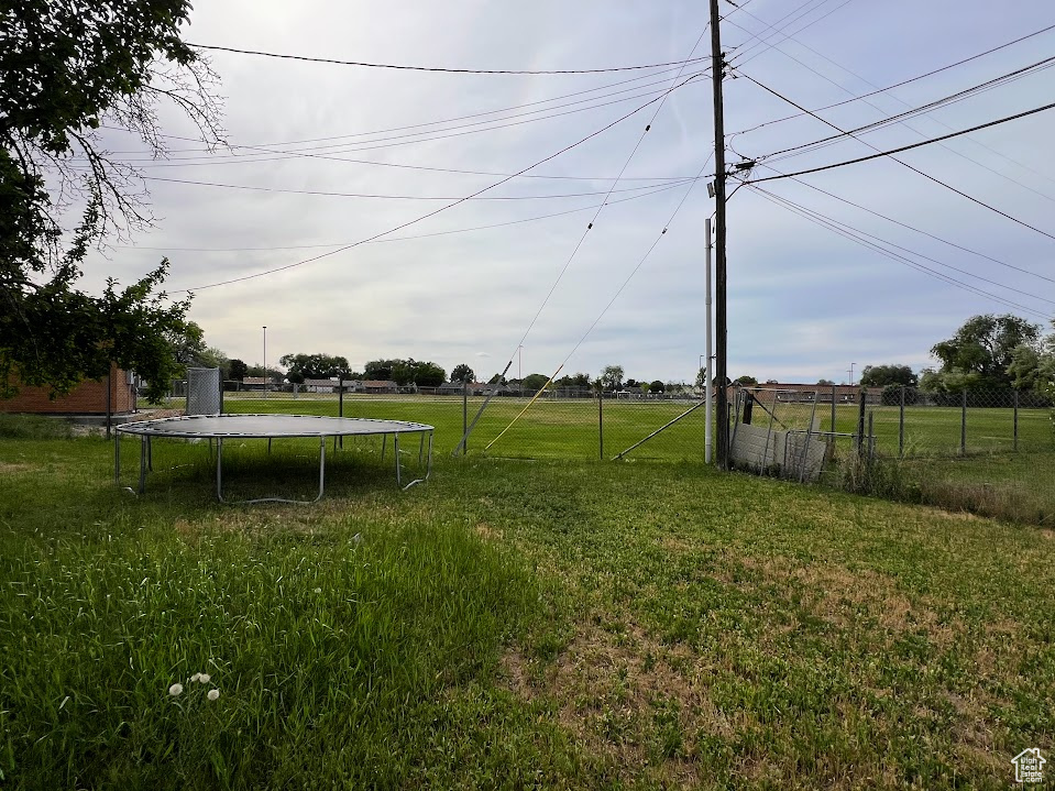 View of yard featuring a trampoline