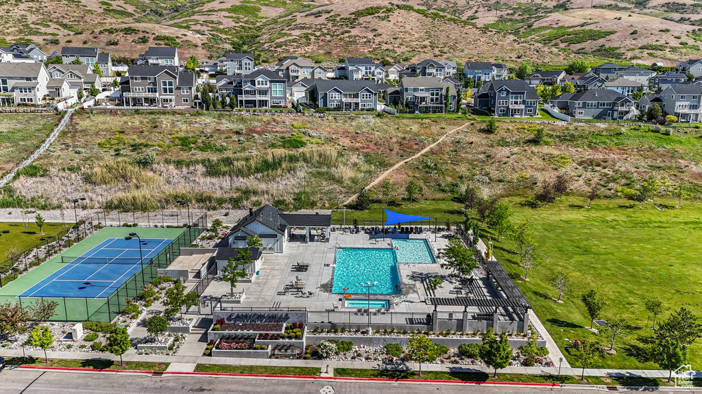 Aerial perspective of suburban area featuring a pool area