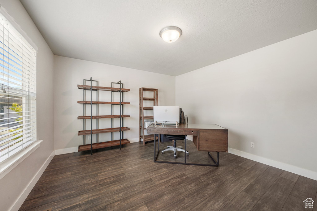 Office with wood finished floors and baseboards