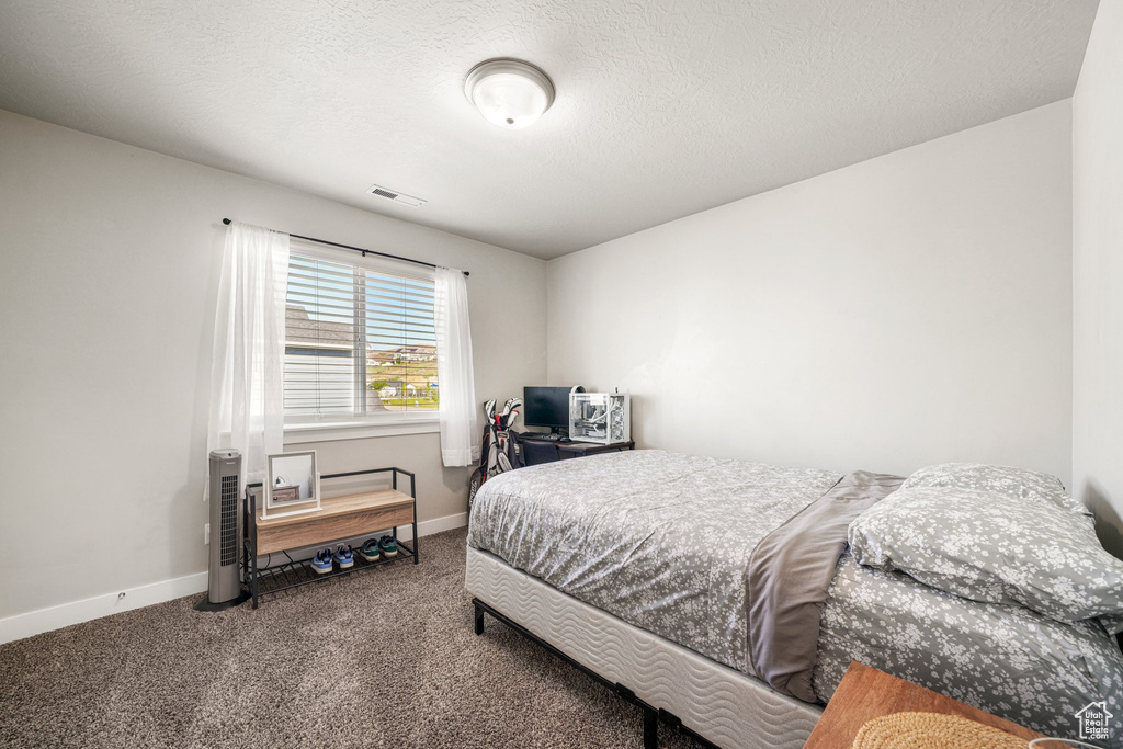 Carpeted bedroom featuring baseboards