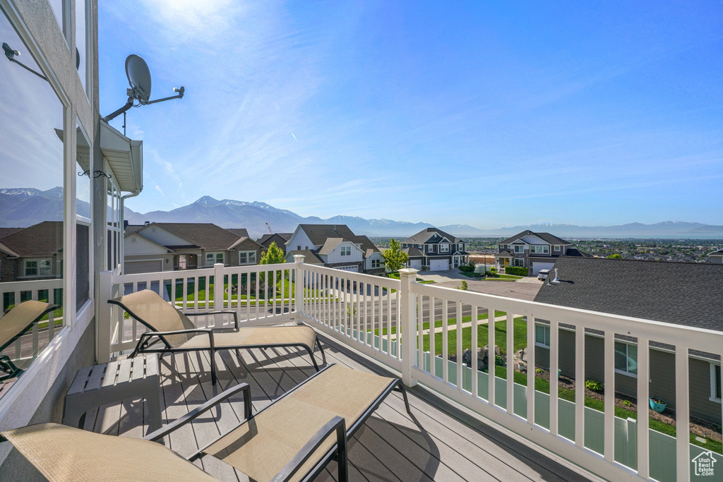Deck with a mountain view and a residential view