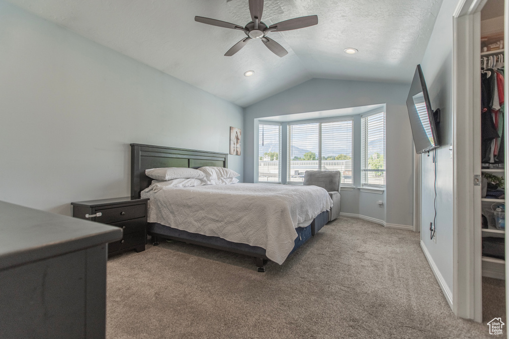 Bedroom featuring lofted ceiling, light carpet, baseboards, a ceiling fan, and recessed lighting