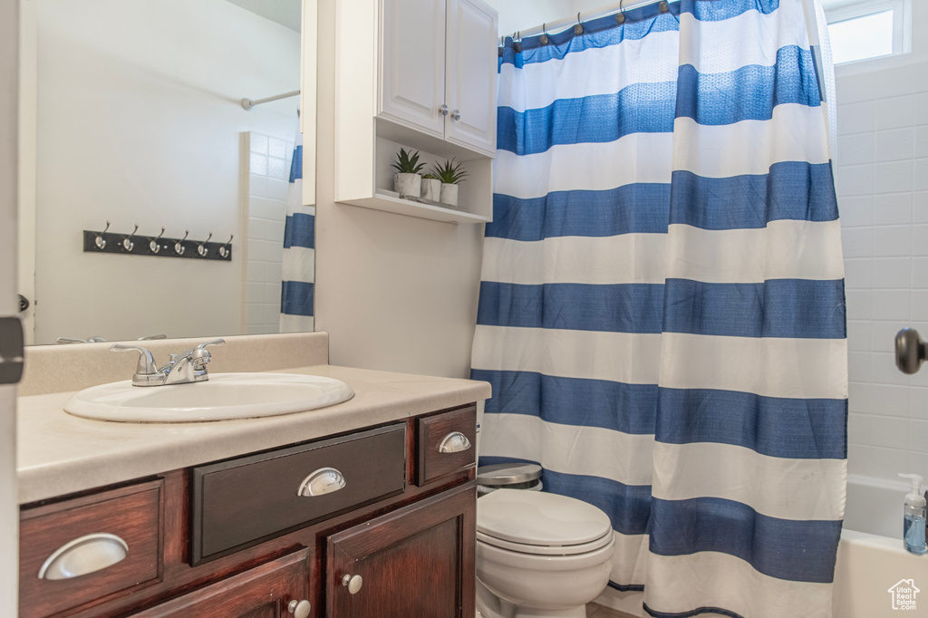 Full bathroom with vanity, toilet, and shower / tub combo