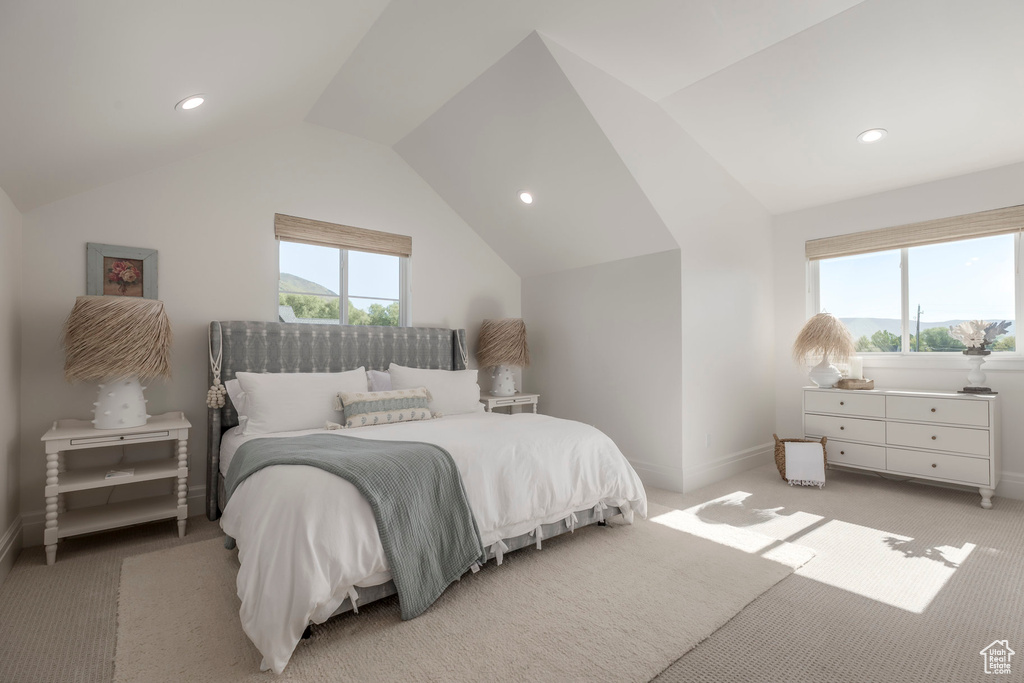 Bedroom with vaulted ceiling, light carpet, baseboards, and recessed lighting