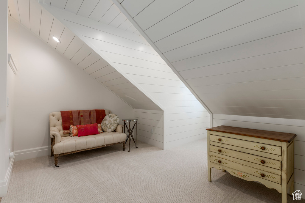 Bonus room with lofted ceiling and carpet