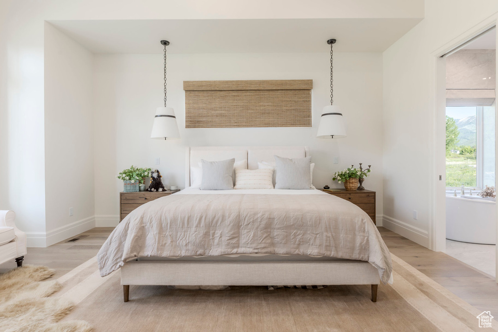 Bedroom with light wood-type flooring and baseboards